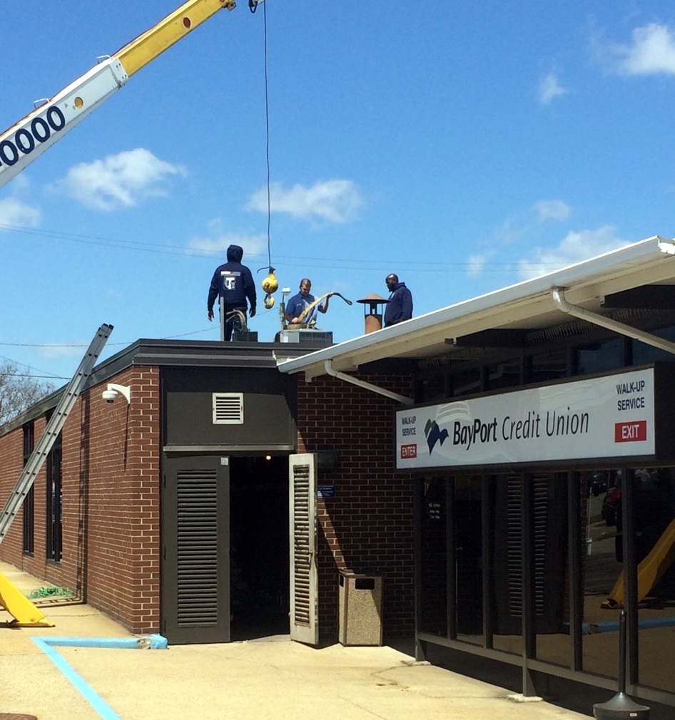 Tommy garner team members installing HVAC unit on top of BayPort Credit Union